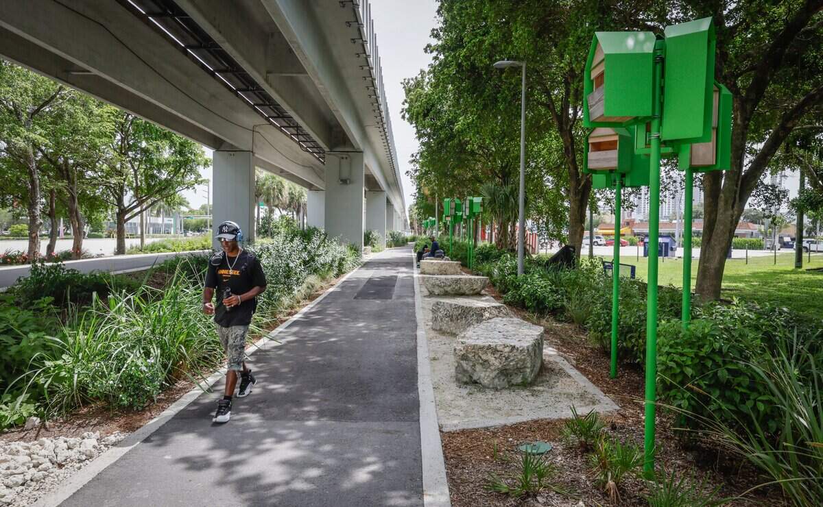 A pedestrian walks the trail sorrounded by native pollinator plants and bird houses along Mariposa Gardens at Segment 9 of The Underline on Tuesday, July 14, 2026 in Miami, Florida. The southernmost 7.36-mile phase extends from SW 65th Avenue to the Dadeland South Metrorail Station.