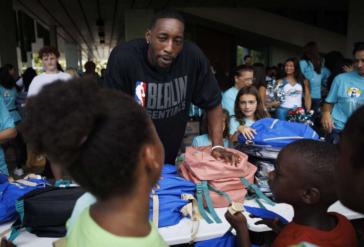 Bam Adebayo, center, hands out backpacks filled with school supplies during his 2026 Back to School Program, on Tuesday, July 28, 2026, at Pérez Art Museum Miami in downtown Miami, Fla.