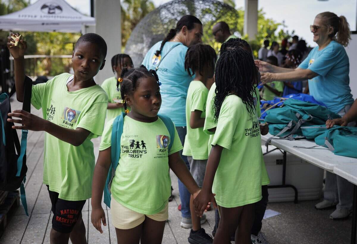 Kids sponsored by FANM, Family Action Network Movement, walk through the line to pick out a backpack filled with school supplies during Bam Adebayo's 2026 Back to School Program, on Tuesday, July 28, 2026, at Pérez Art Museum Miami in downtown Miami, Fla.