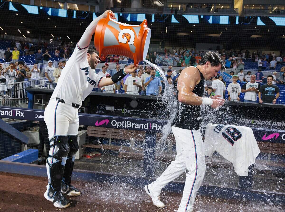 Miami Marlins catcher Joe Mack (80) pours Gatorade on right fielder Griffin Conine (18) after Conine hit a walk off single to win the game against the Philadelphia Phillies during the ninth inning on Monday, July 27, 2026, at loanDepot Park in Miami, Fla.