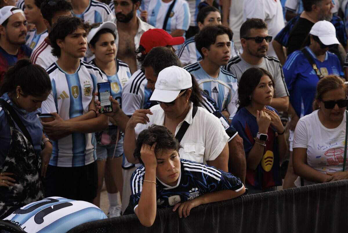 Argentina fans react to Spain winning 1-0 in extended time  during a watch party for the 2026 FIFA World Cup Final on Sunday, July 19, 2026, at the Miami Beach Bandshell in Miami Beach, Fla.