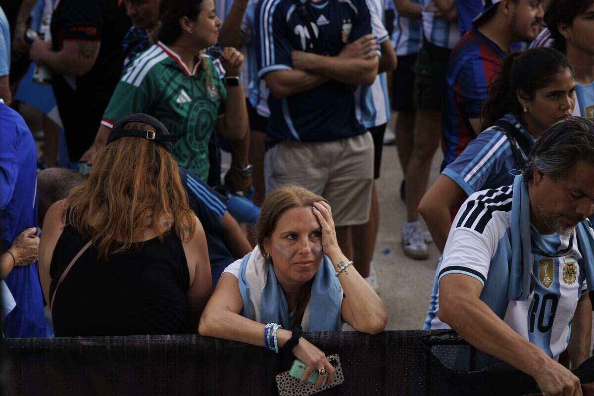 An Argentina fan reacts to Spain winning the 2026 FIFA World Cup Final 1-0 in extended time during a watch party at the Miami Beach Bandshell on Sunday, July 19, 2026, in Miami Beach, Fla.