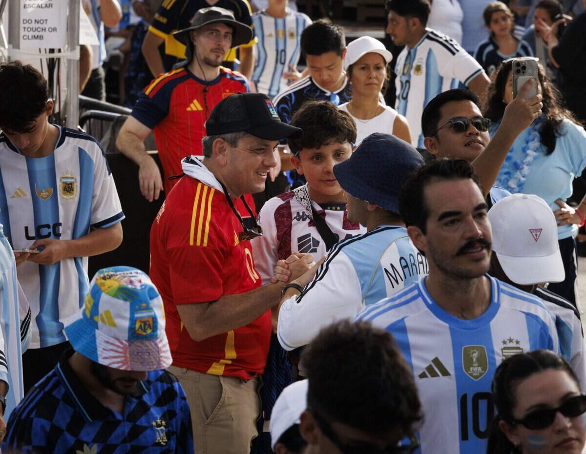 A Spain fan and an Argentina fan shake hands after Spain won the 2026 FIFA World Cup Final during a watch party at the Miami Beach Bandshell on Sunday, July 19, 2026, in Miami Beach, Fla.