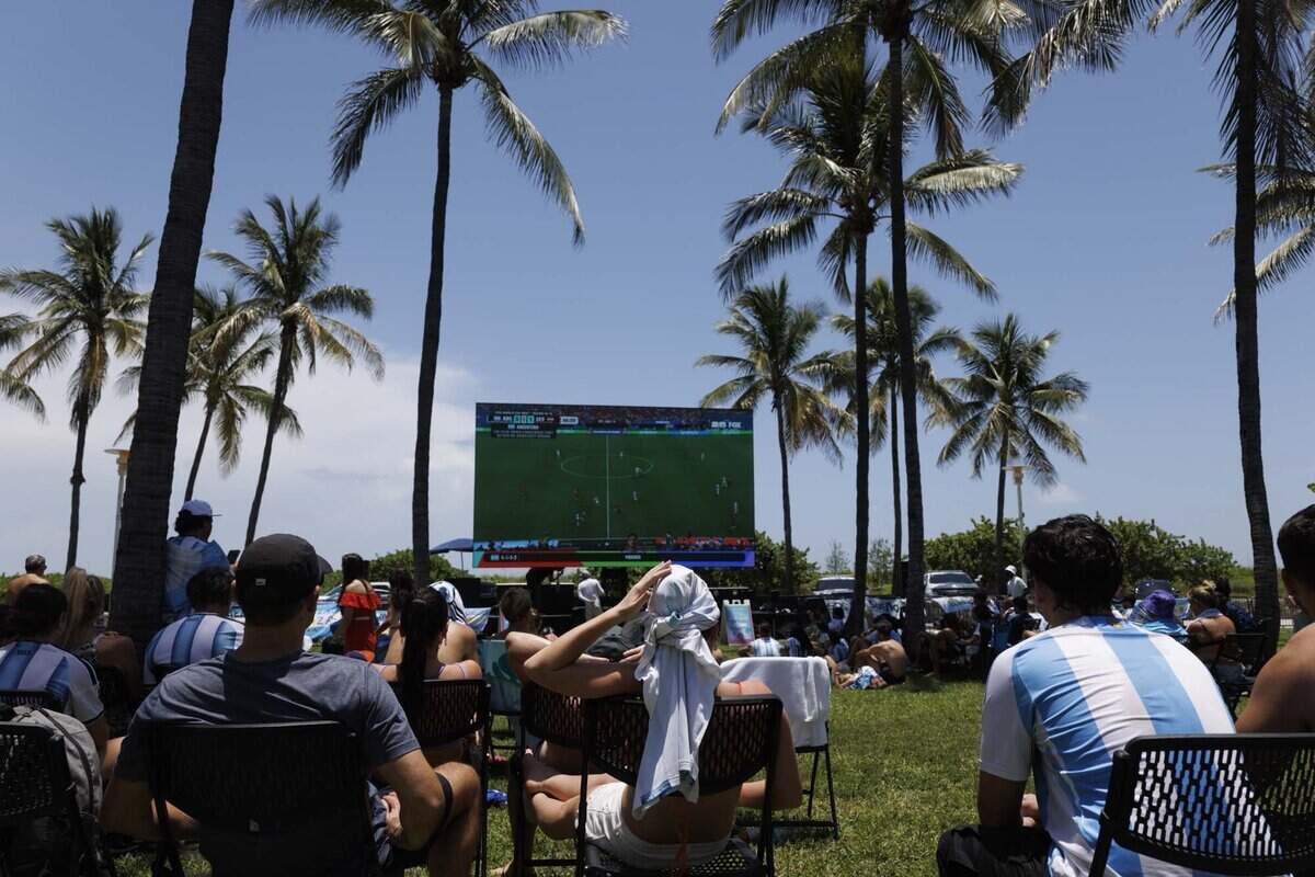 Fans watch the FIFA World Cup at a watch party during a heat advisory as they watch Argentina play Egypt on Tuesday, July 7, 2026, at Lummus Park in Miami Beach, Fla.