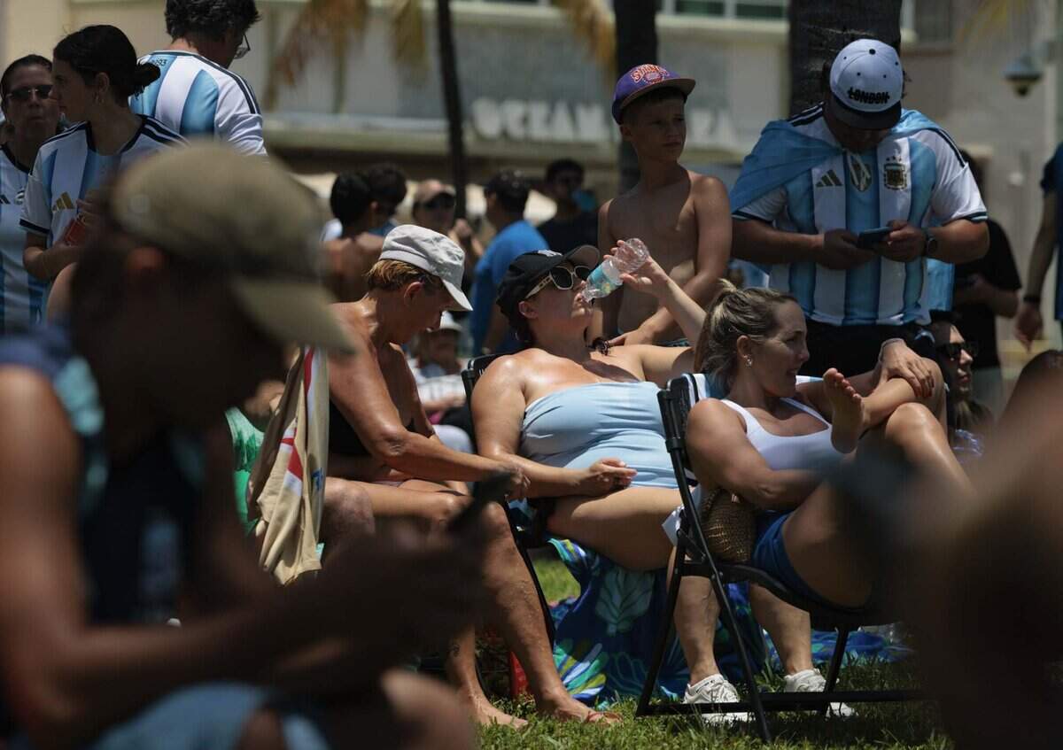 Fans watch the FIFA World Cup at a watch party during a heat advisory as they watch Argentina play Egypt on Tuesday, July 7, 2026, at Lummus Park in Miami Beach, Fla.