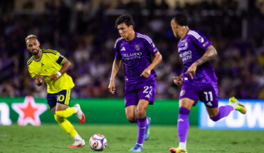 Image of Justin Ellis dribbling the ball with Tiago to his left and Nashville's Hany Mukhtar defending to his right.