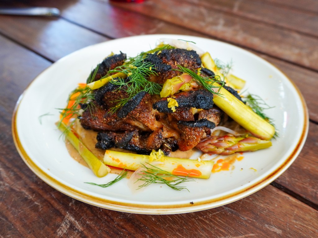 a roasted mushroom dish on a white plate with vegetables 