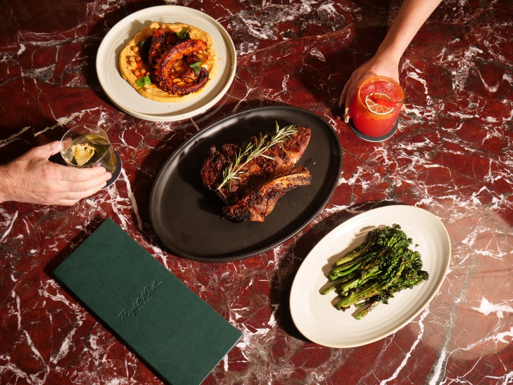 a spread of dishes on a burgundy marble table