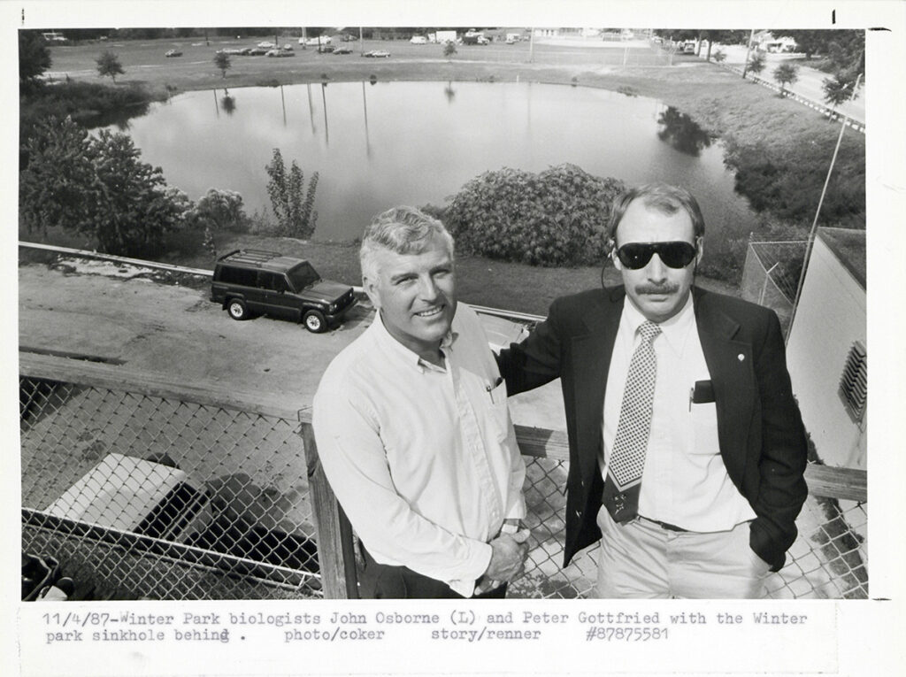 Researchers John Osborne and Peter Gottfried overlook the former sinkhole during research into the site’s transformation into a functioning lake ecosystem.