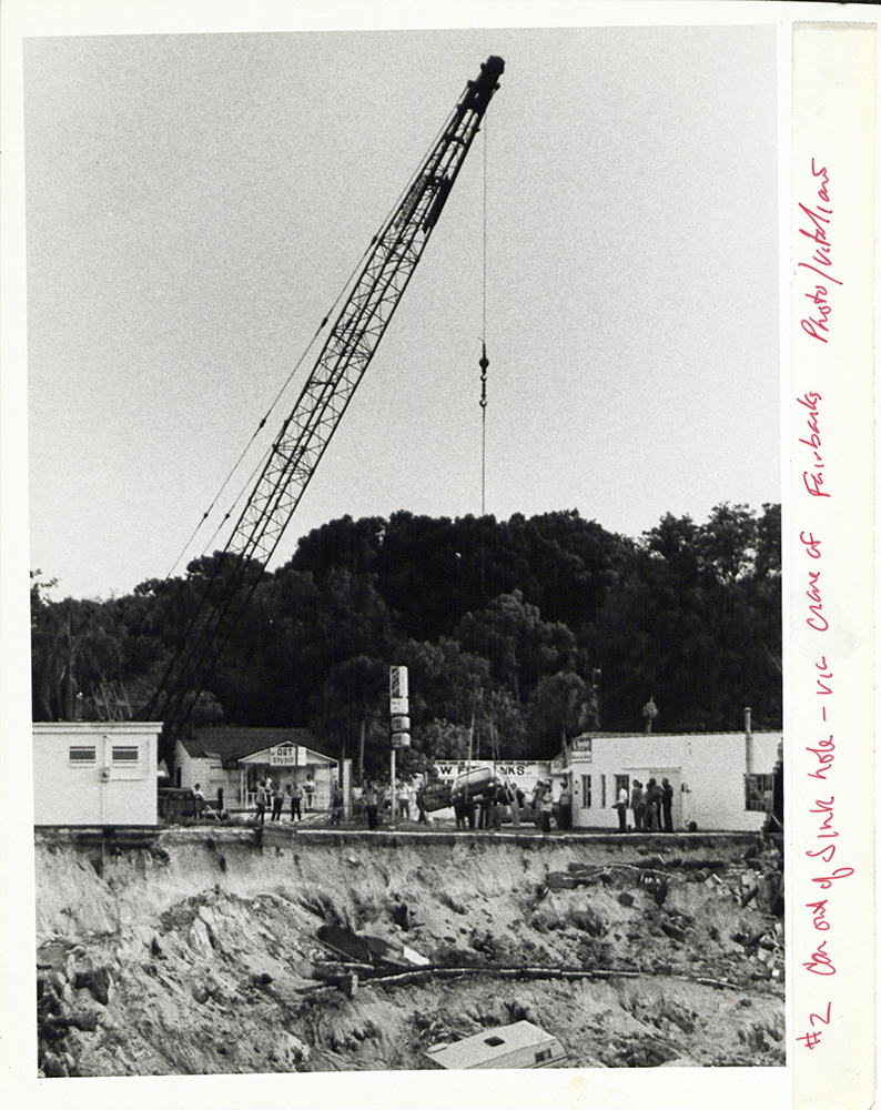 Photo of a crane near the edge of the Winter Park sinkhole