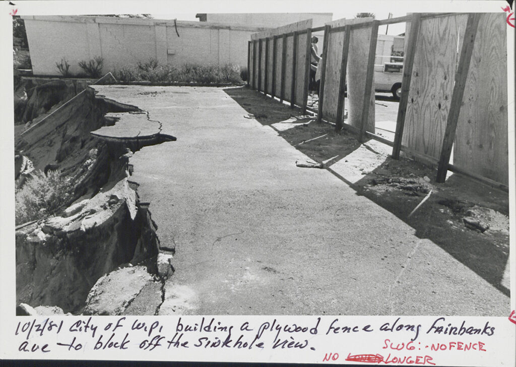 plywood fence around portions of the sinkhole site in October 1981
