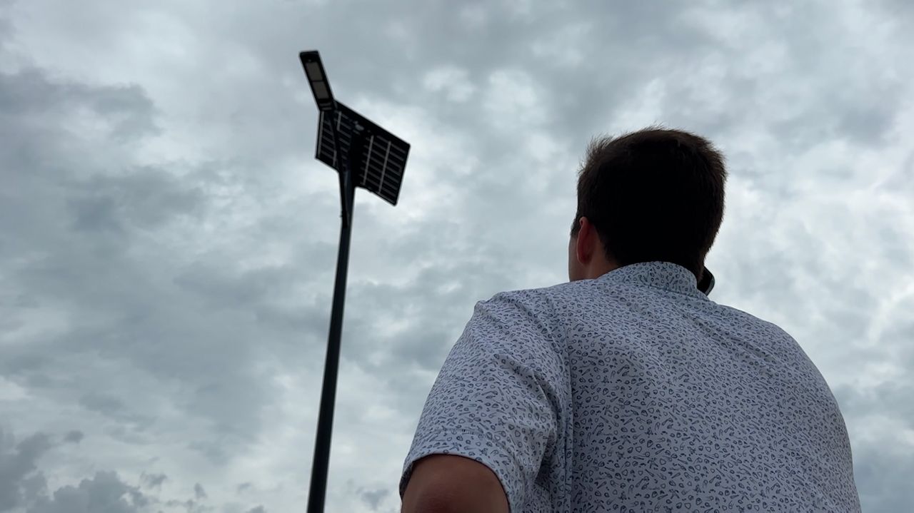 With a simple phone call, Liam Ryan says, "Let there be light," as one of his Streetleaf streetlights illuminates a block in the new Pasadena Ridge community. The Tampa based company is making sure the lights stay on in neighborhoods even in the aftermath of a storm. (Spectrum News/Calvin Lewis)
