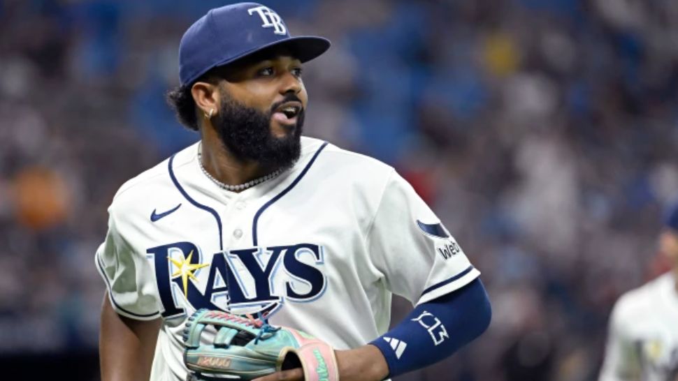Tampa Bay Rays third baseman Junior Caminero watches a replay on his way to the dugout after the final out of the top of the seventh inning of a baseball game against the Seattle Mariners, Friday, July 10, 2026, in St. Petersburg, Fla. (AP Photo/Jason Behnken)