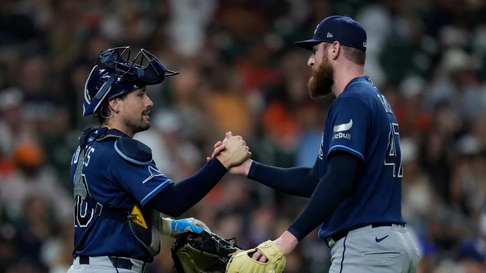 Tampa Bay Rays catcher Nick Fortes and pitcher Bryan Baker celebrate after a baseball game against the Houston Astros, Friday, July 3, 2026, in Houston. (AP Photo/Kevin M. Cox)