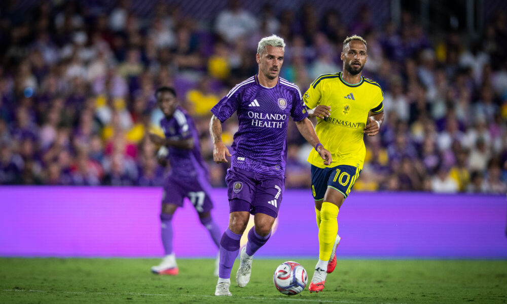 Image of Antoine Griezmann dribbling the ball past Hany Mukhtar of Nashville.