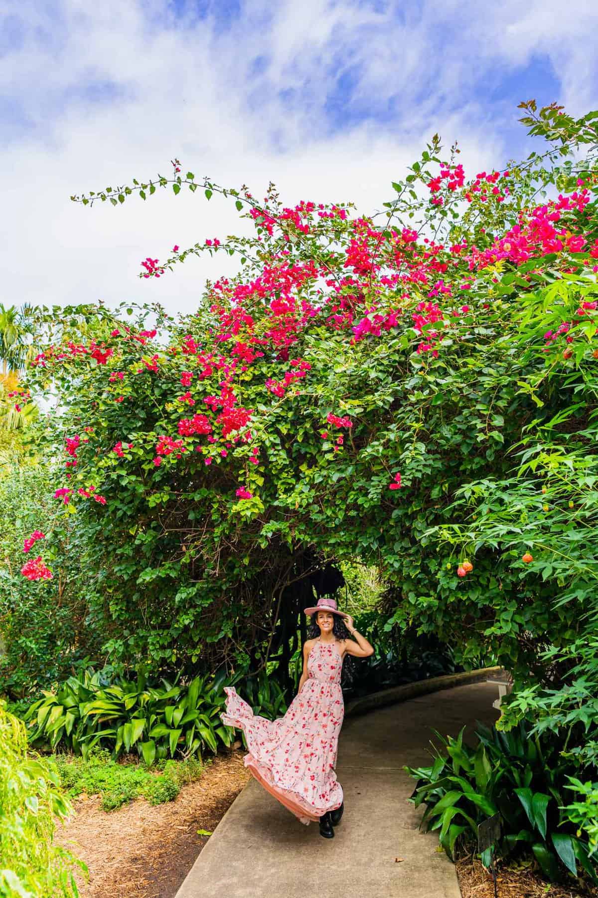 Jessica standing under some flowers in a garden in St. Petersburg