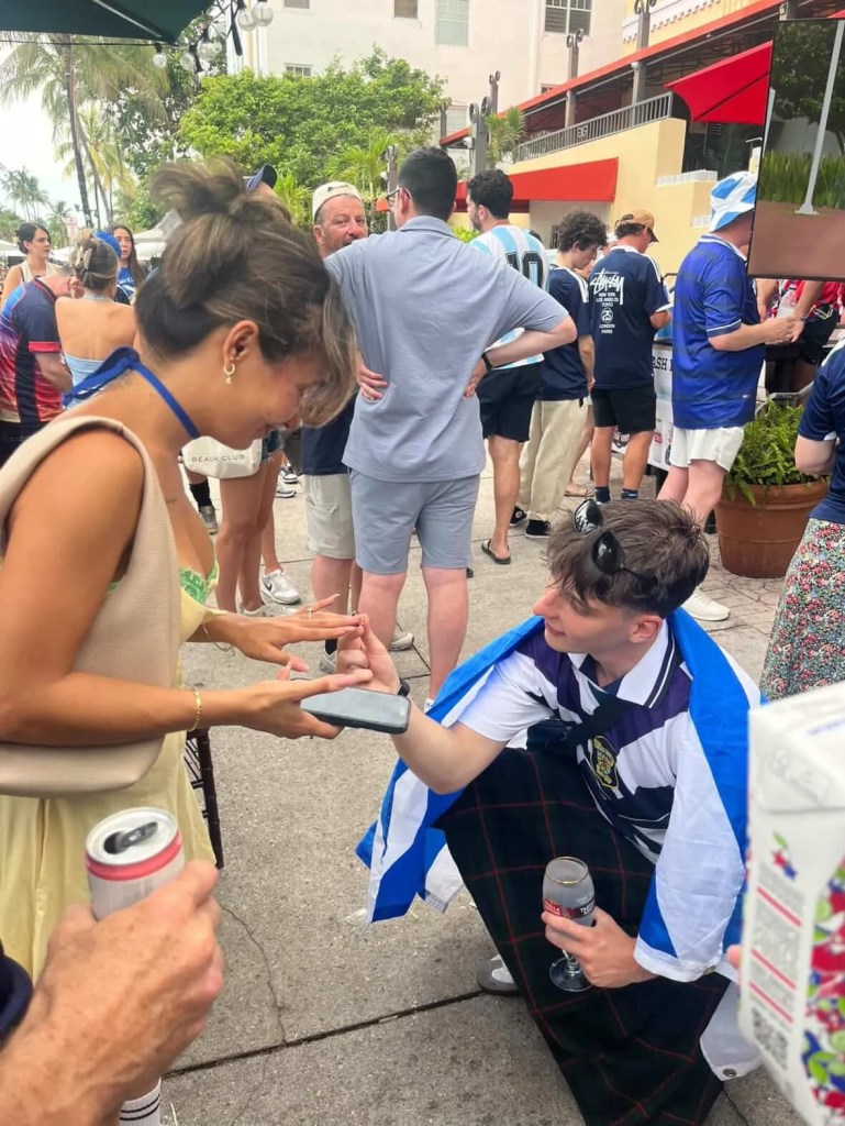 a man proposes to a woman on the street