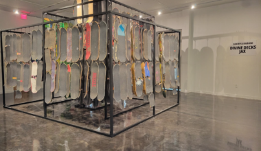 Shows a contemporary art piece of skateboards hanging in an art gallery