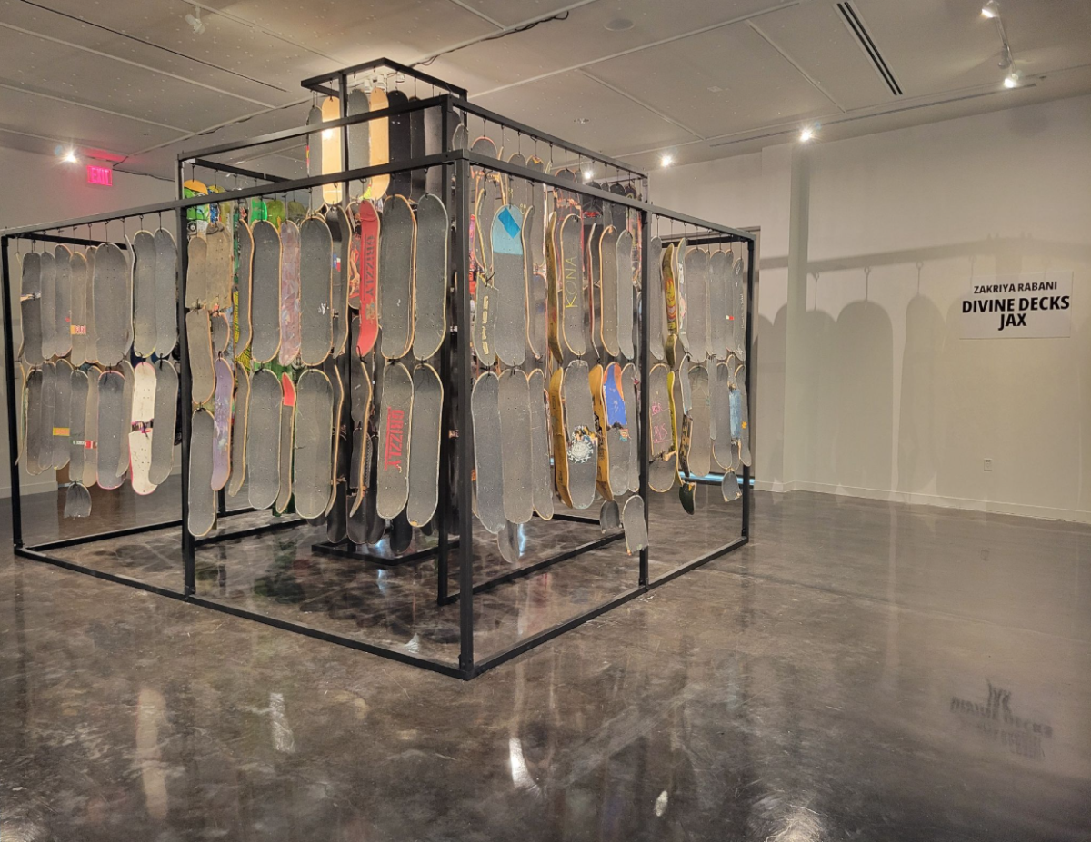 Shows a contemporary art piece of skateboards hanging in an art gallery