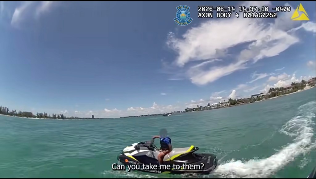 Bodycam footage from the Sarasota Police Department showing a person on a jet ski asking "Can you take me to them?"