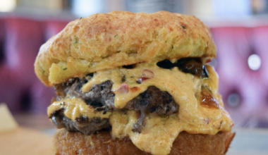 This specialty, limited-time burger features two pressed beef patties, pimento cheese, fried green tomato, bacon, and jalapaño jam between a cheddar-chive biscuit.