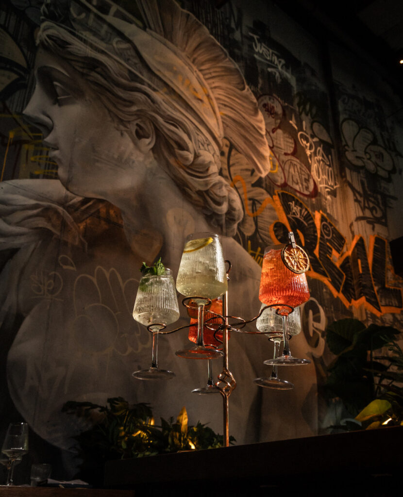Drinks in front of a mural