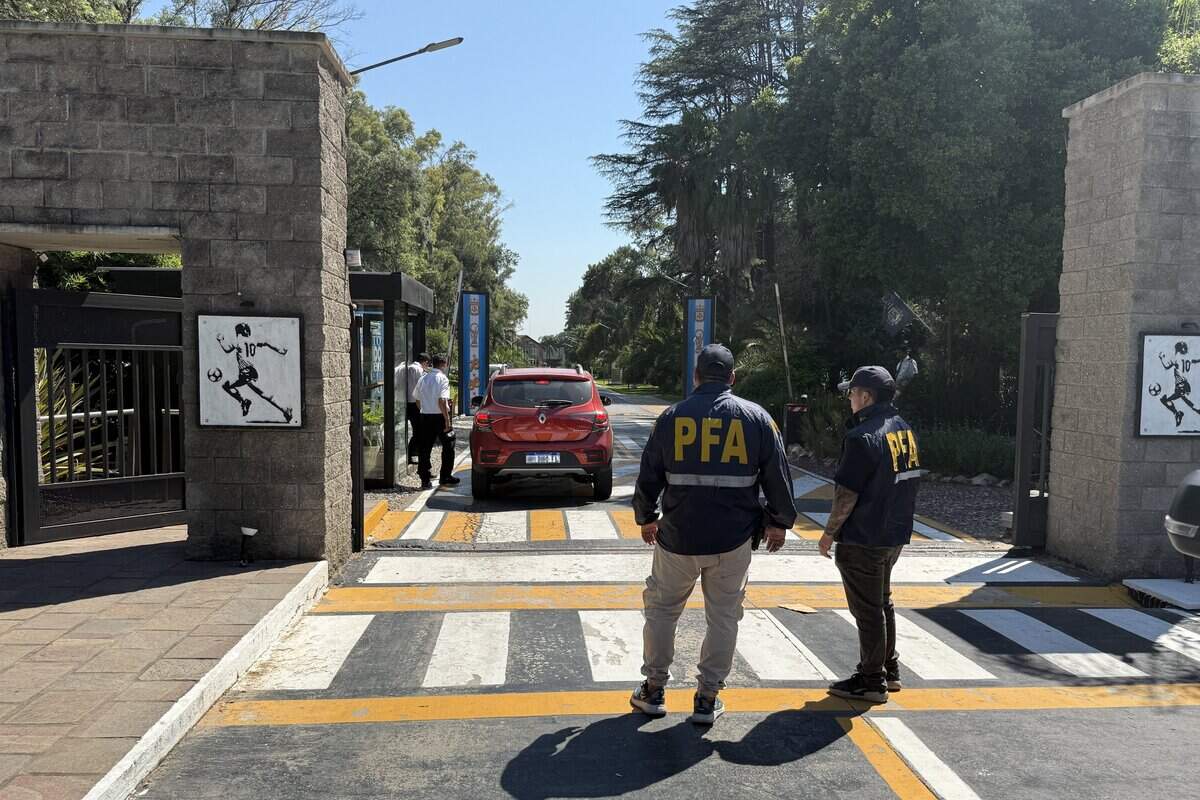 Federal police agents stand outside the Argentine Football Association (AFA) training facility in Ezeiza, Buenos Aires Province, on December 30, 2025, during a police raid. Police raided the headquarters as part of an investigation into alleged tax evasion. (Photo by Magali CERVANTES / AFP via Getty Images)