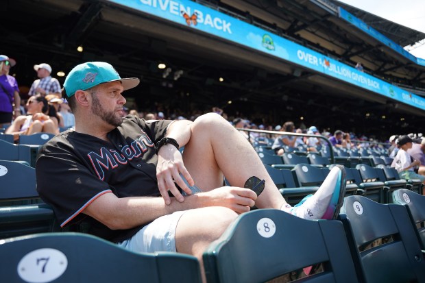 Miami Marlins fan Alex Pellerano of Australia, watches on as the Rockies score runs against the Marlins at Coors Field in Denver on Thursday, July 2, 2026. The Marlins would fall to the Rockies 14-4. (Photo by Harmon Dobson/The Denver Post)