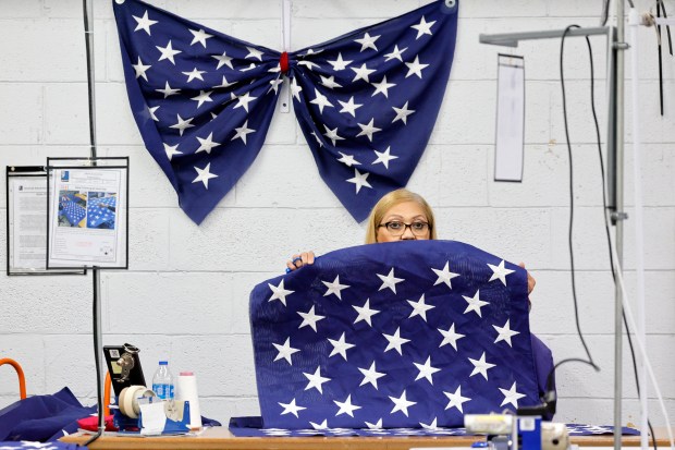 Iris Perez, of Hallandale Beach, flips over a panel of stars for a U.S. flag at the Goodwill Industries of South Florida headquarters in Miami on Tuesday, June. 30, 2026. (Amy Beth Bennett / South Florida Sun Sentinel)