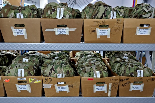 Combat uniform trousers are stacked on a shelf at the Goodwill Industries of South Florida headquarters in Miami on Tuesday, June. 30, 2026. (Amy Beth Bennett / South Florida Sun Sentinel)