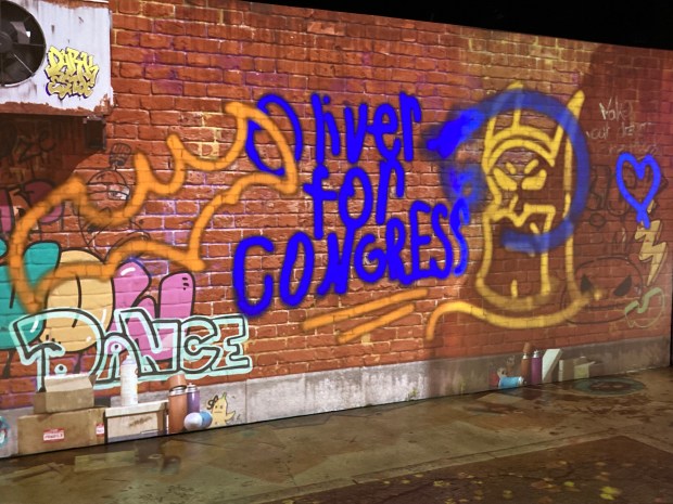 Supporters of congressional candidate Oliver Larkin, a democratic socialist running in 2026 Democratic nomination in South Florida's 25th Congressional meeting, created digital graffiti showing support for the candidate at a town hall meeting at MAD Arts in Dania Beach on July 23, 2026. (Anthony Man/South Florida Sun Sentinel)