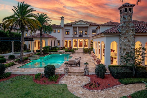 The backyard retreat evokes the feeling of Lake Como, with picturesque sightlines, expansive lake views and covered outdoor living areas featuring fireplaces that surround the resort-style pool. (Photo by Harvey Smith)