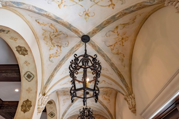 Bespoke details, like hand-painted frescos on the ceiling, carry the consistent theme across every room. (Photo by Harvey Smith)