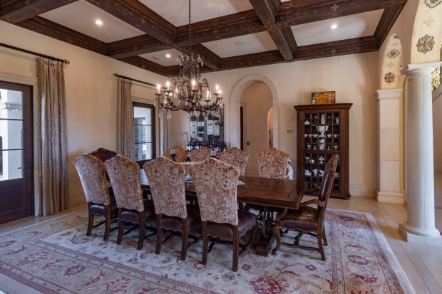 The formal dining room is complemented by hand-painted wood beams. (Photo by Harvey Smith)