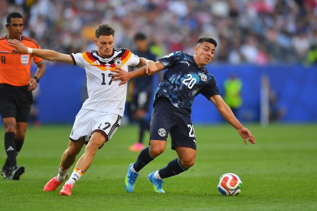 Paraguay's Braian Ojeda (20) battles for the ball with Germany's Florian Wirtz (17) during the World Cup round of 32 soccer match in Foxborough, Mass., near Boston, Monday, June 29, 2026. (AP Photo/Steven Senne)