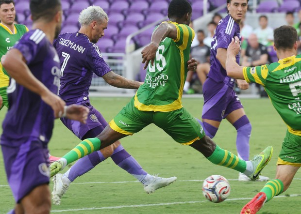 Orlando City player Antoine Griezmann (7) scores a goal between the legs of Tampa Bay players during the Tampa Bay Rowdies at Orlando City Soccer friendly match at Inter&Co Stadium in Orlando on Wednesday, July 8, 2026. (Stephen M. Dowell/Orlando Sentinel)