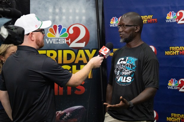 Olympia High School coach Travis Gabriel interviews with WESH Channel 2 during varsity media day for football teams from Orange and Osceola counties at 407 Sports Training Center in Ocoee, FL, on Saturday July 25, 2026. (Barrett Walsh/Orlando Sentinel)