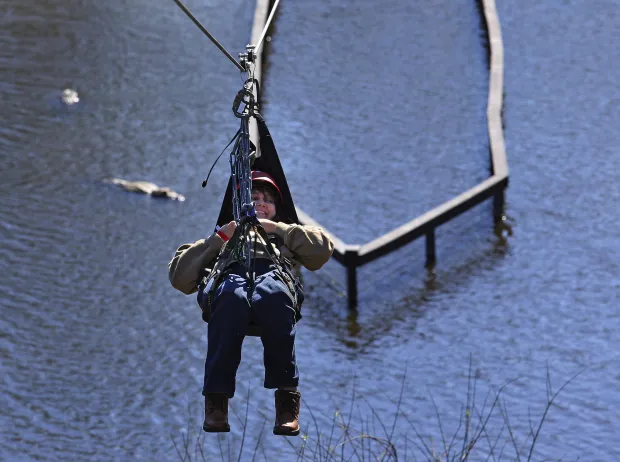 Former Miss Wheelchair Florida 1999, Christina Martin, 43, ZipLines for the first time Friday, February 5, 2016 at Gatorland. Gatorland is launching its newest zip line, Gator Gauntlet, an attraction accessible to park guests with mobility challenges and other disabilities. The wheelchair-accessible ride goes down a 350-foot wire and over the park and, yes, alligators. Park spent $500,000 on this, and is doing three days of promotions (Feb. 4-6) with kids, veterans and other groups.(Red Huber/Staff Photographer) ORG XMIT: ORL1602051513546413