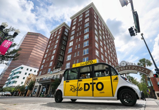 ​​A Ride DTO shuttle passes the Angebilt Hotel building, built in 1923, at 37 North Orange Ave. in Orlando, Tuesday, June 2, 2026. The City of Orlando is considering easing restrictions on development in its downtown historic district that could impact older properties. (Joe Burbank/Orlando Sentinel)