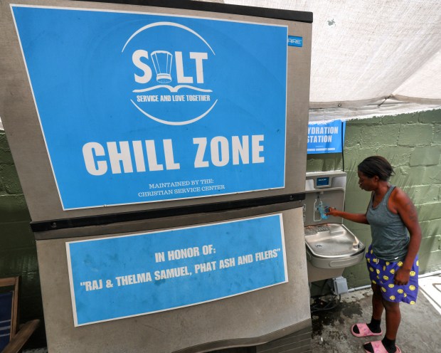 With the heat index near 100 degrees, clients cool off at the makeshift outdoor cooling center at SALT Outreach on S. Orange Blossom Trail, Wednesday, July 1, 2026. The mobile facility provides homeless with showers, laundry and counseling and is adjacent to Powerhouse Church's air-conditioned center that operates on days when index temperatures reach 103. (Joe Burbank/Orlando Sentinel)