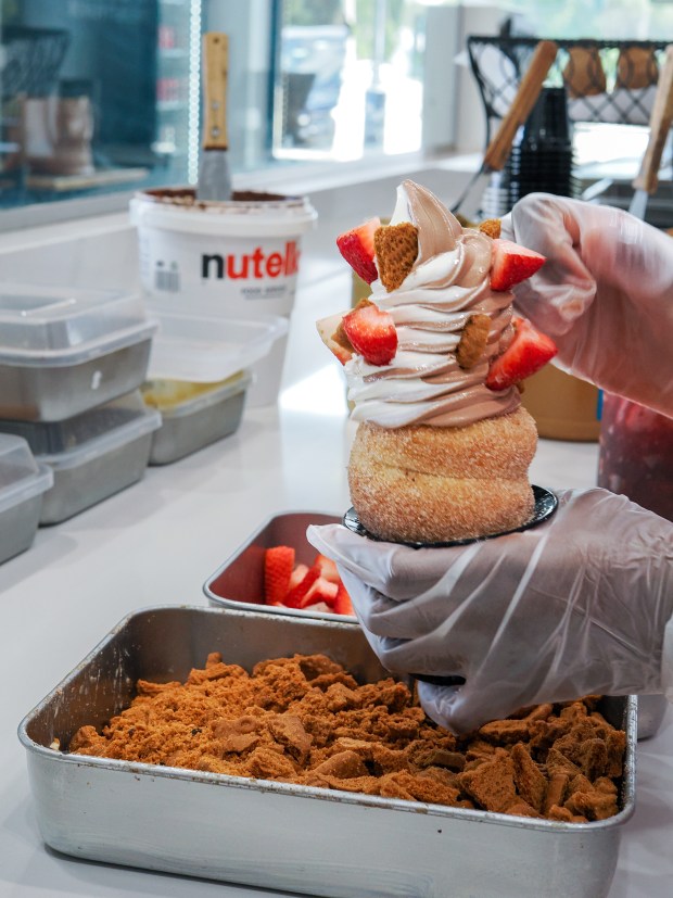 A staffer assembles a swirl soft serve Crispy Cone at the brand's shop in Orlando's Curry Ford West neighborhood. (Photo courtesy Lisa Wilk/TasteCookSip.com)