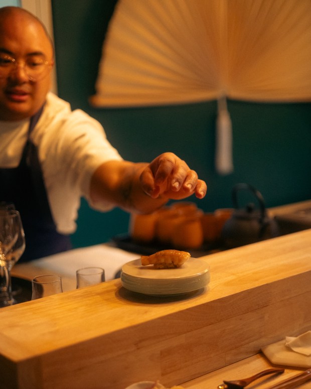 Sushi Saint Chef/Owner Michael Collantes puts the finishing touch on a piece of nigiri at their Creative Village/Downtown location. (Photo courtesy Fernando Delgado)