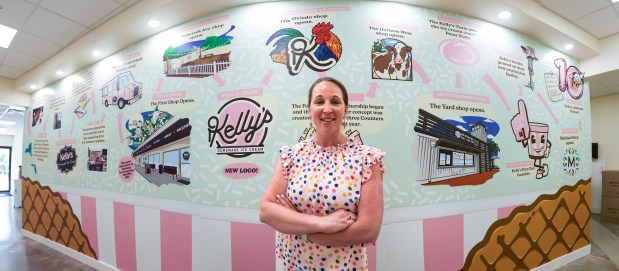 Kelly Seidl, founder of Kelly's Homemade Ice Cream, stands in front of a timeline that marks her ice cream journey. It is located at the company's production facility in Altamonte Springs. Tours will be available soon. (Joe Burbank/Orlando Sentinel)