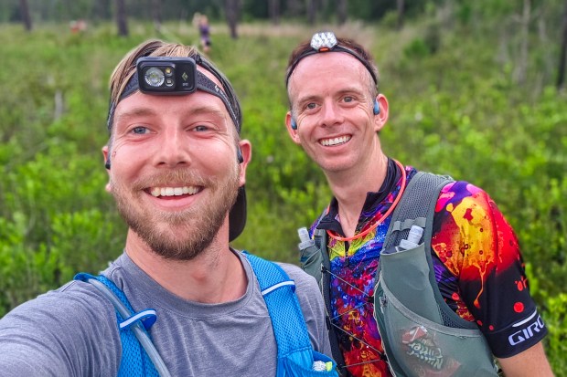 Patrick Connolly, left, and Kevin Bolton pause for a selfie during the Skunk Ape Night Run in Green Swamp on July 18, 2026. (Patrick Connolly/Orlando Sentinel)