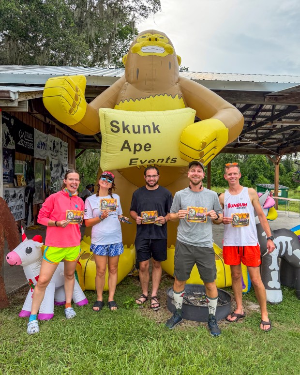 Runners from Orlando, from left, Hanna Dohm, Danica Bolton, David Jacobelli, Patrick Connolly and Kevin Bolton represent O-Town Blazers during the Skunk Ape Night Run in Green Swamp on July 18, 2026. (Patrick Connolly/Orlando Sentinel)