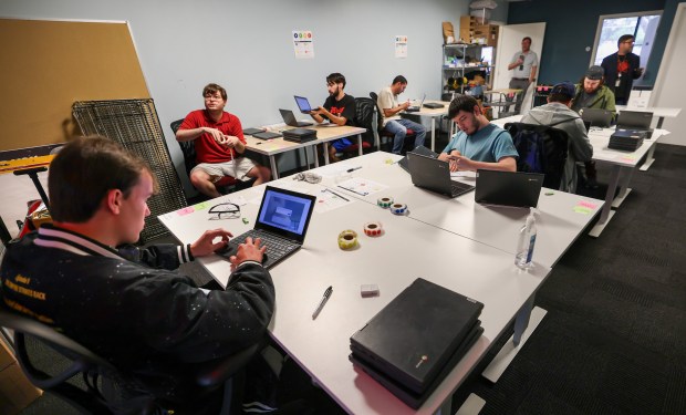 Techtonic apprentice Thomas Burke, left, assesses the condition of used Chromebooks at the company's Winter Park headquarters, Monday, July 27, 2026. Techtonic is a division of the Jonathan's Landing Foundation that trains neurodivergent employees to become certified IT technicians. (Joe Burbank/Orlando Sentinel)