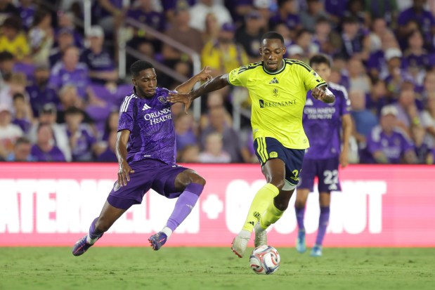 Jordan Knight #23 of Nashville SC is challenged by Tyrese Spicer #14 of Orlando City during the MLS match between Orlando City SC and Nashville SC at Inter&Co Stadium on July 25, 2026 in Orlando, Florida. (Photo by Dustin Markland/Getty Images)