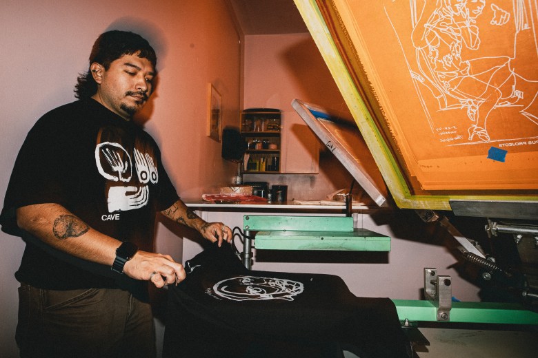 A screenprinter at Tempus Projects' Oh, Cuore Mia exhibit