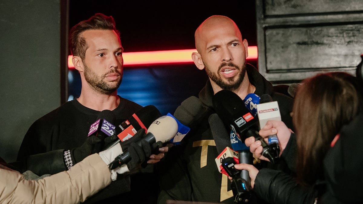 Andrew Tate talks to the media outside his residence in Bucharest, Romania.