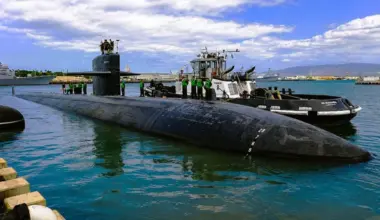 Sailors stand atop the USS Jacksonville submarine.